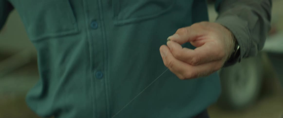 A man is cutting the fishing line