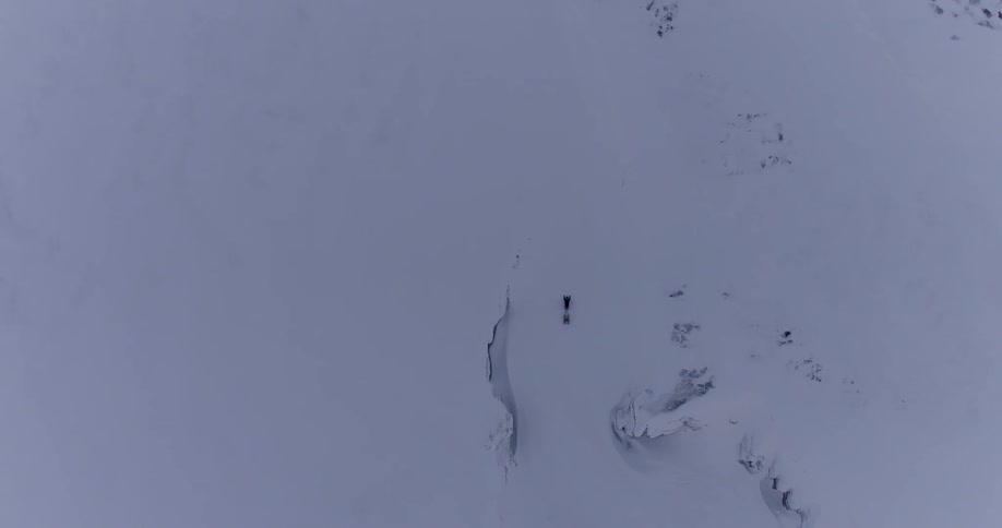 A person rides a snowmobile in the snow