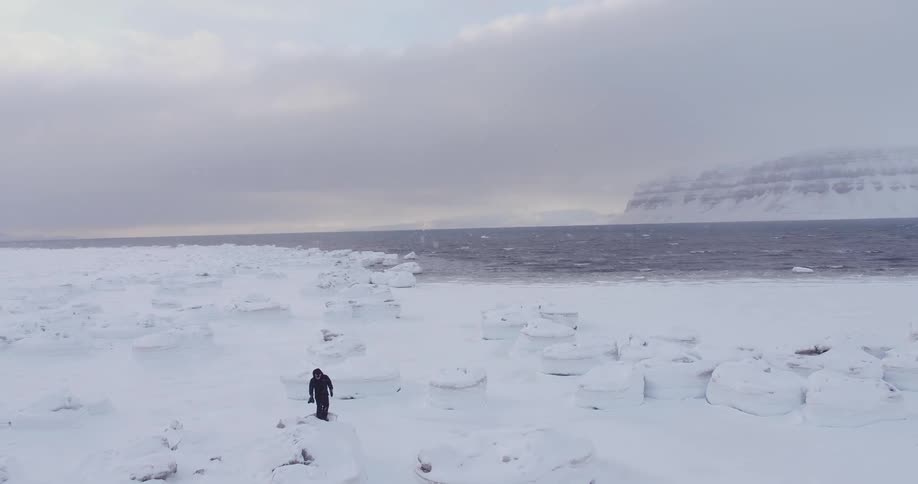 Person taking photographs in the arctic wilderness