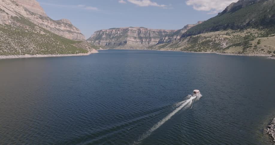 The speed boat travels in the large river