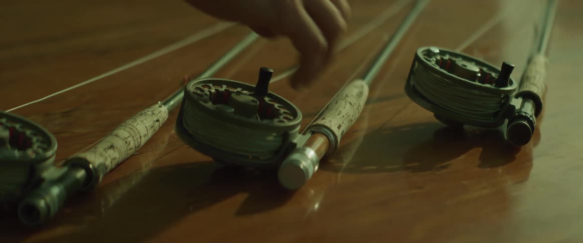 A person is picking up a fishing rod