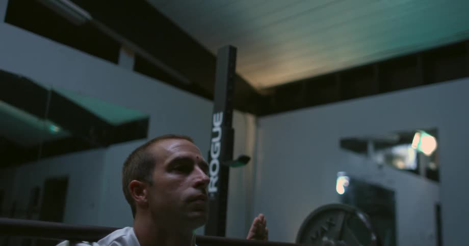 Man lifts weights in a gym