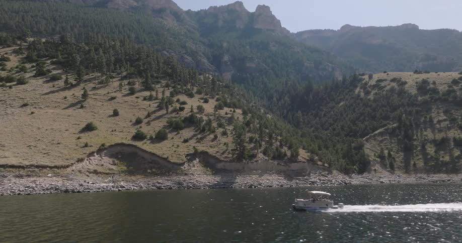 People riding a boat on a mountain lake