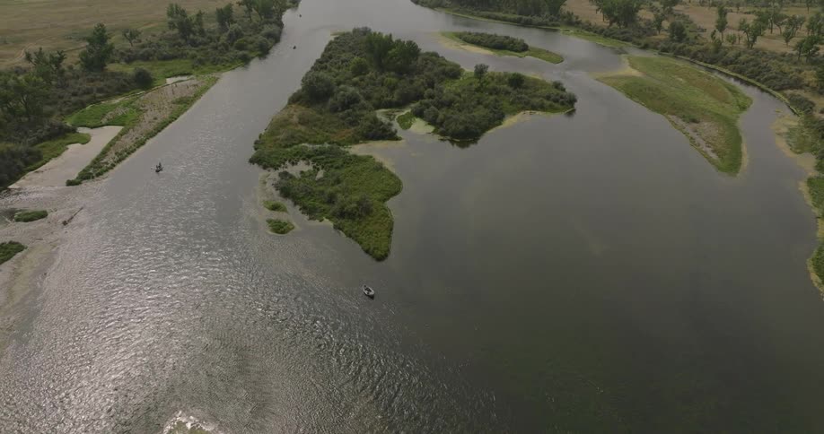 Aerial view of a river with small boats and green areas