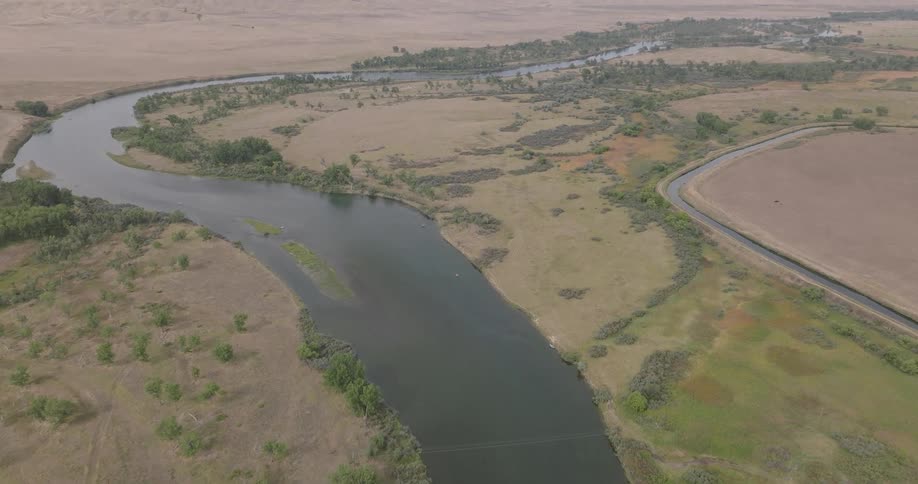 Aerial view of a winding river in an area surrounded by vegetation