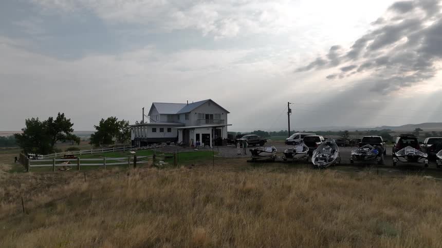 Boats are in front of the rural home