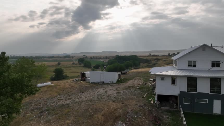 Aerial view of a house on a hill in a natural area
