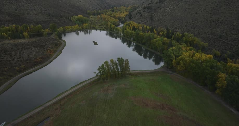 Aerial view of a farm pond between mountains