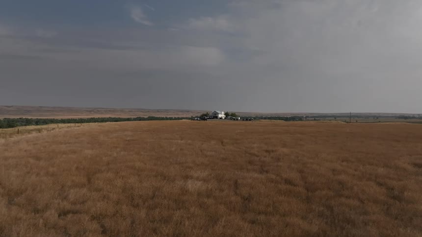 A home is at the end of a long field