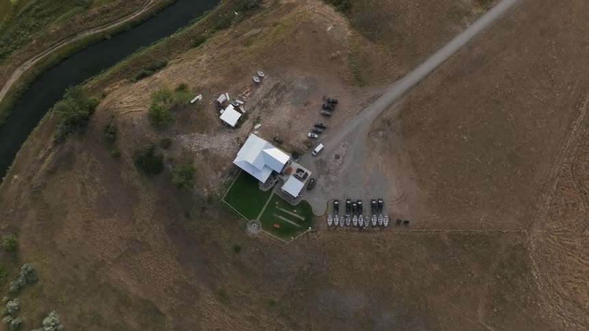 Cars are parked around the home on the farm