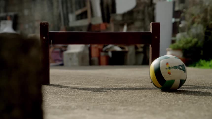 Leg of a person pulling a ball with their feet