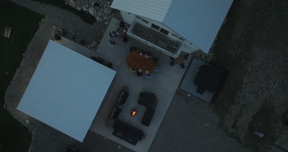 A small bonfire is in the yard of the home