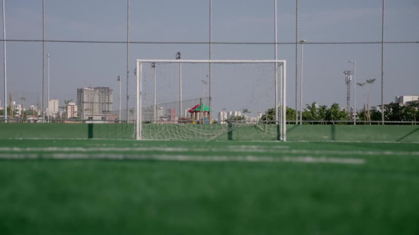 A net is on the empty soccer field on a cloudy day
