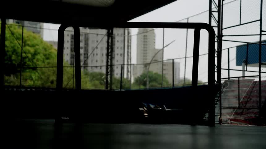 Skyscrapers and a few trees are visible through the openings in a sort of pavilion
