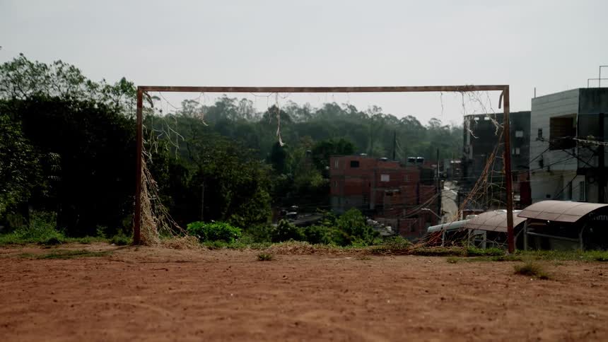 A soccer net is on a hill above the town