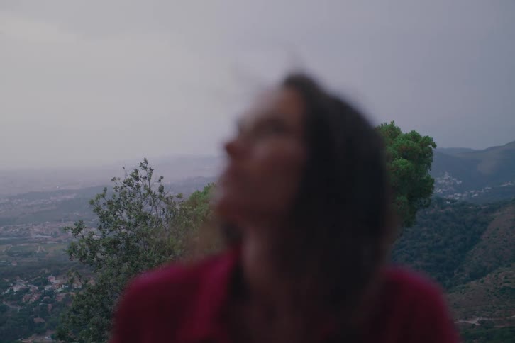 Wind blows the womans hair on a foggy day