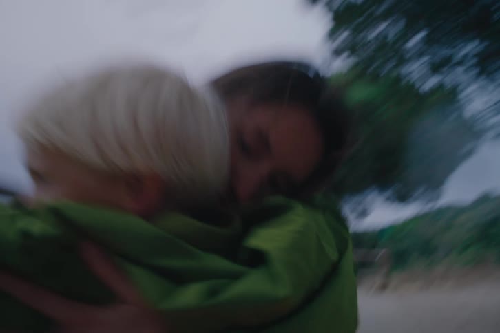 Mother lovingly hugging her son