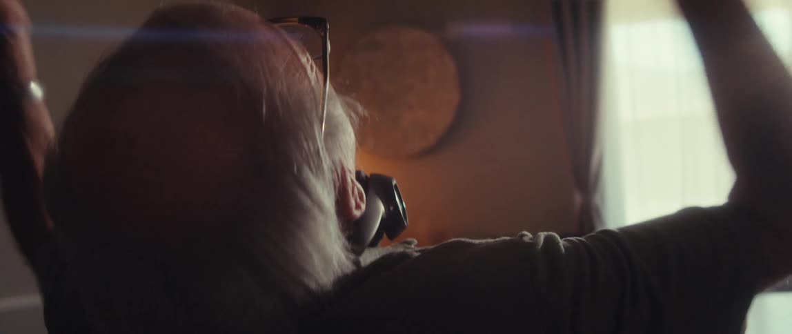 Elderly man celebrates a stock market win at his desk