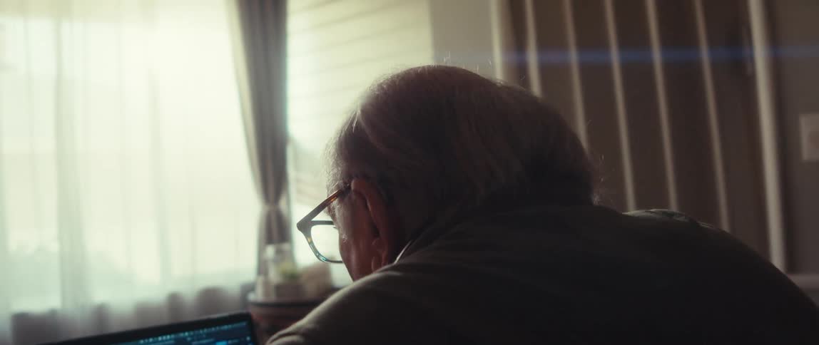 Man pumps his fist and cheers when reading information on the computer