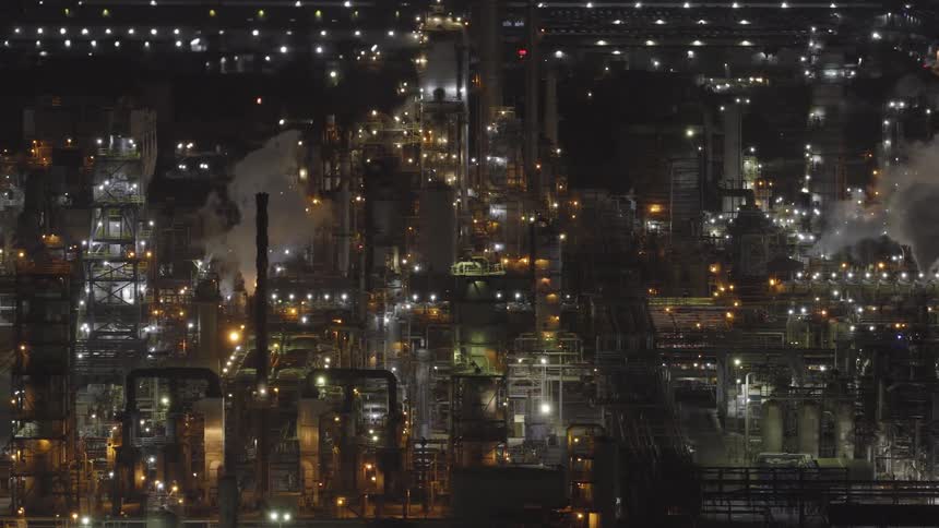 The large factory is giving off smoke pollution