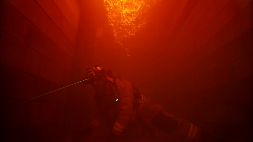 Firefighters using advanced technology pass under a burning ceiling