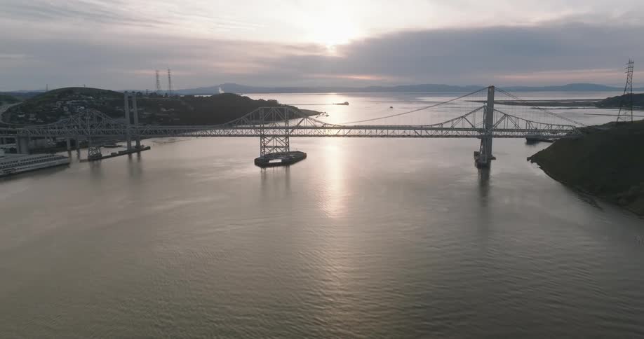 A bridge spans a river with a city on both sides