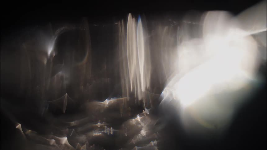 Soft white light leaks and lens flares dancing across the screen the ethereal and shimmering effects create a dreamlike or atmospheric visual