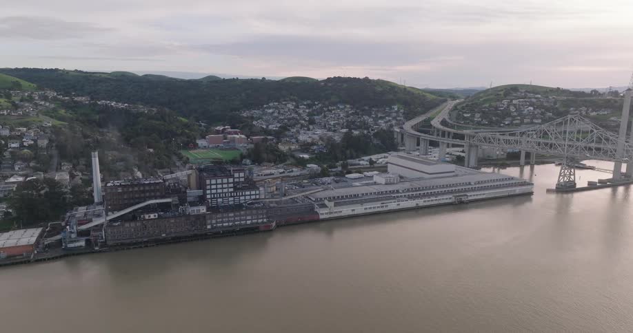 A bridge spanning a river to cut through a dense neighborhood