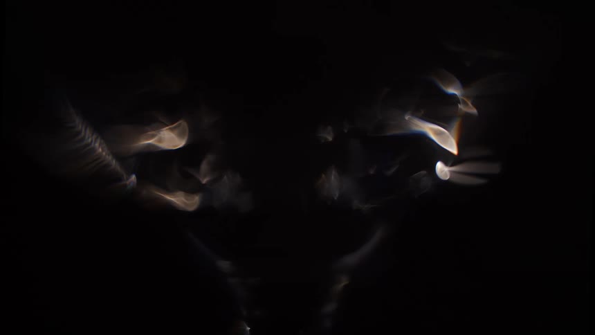 Gleaming light outlines the shape of an object in the dark