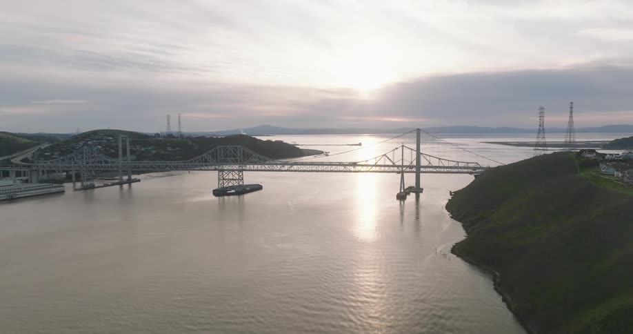 Aerial view of a sea canal with bridges and city in the background