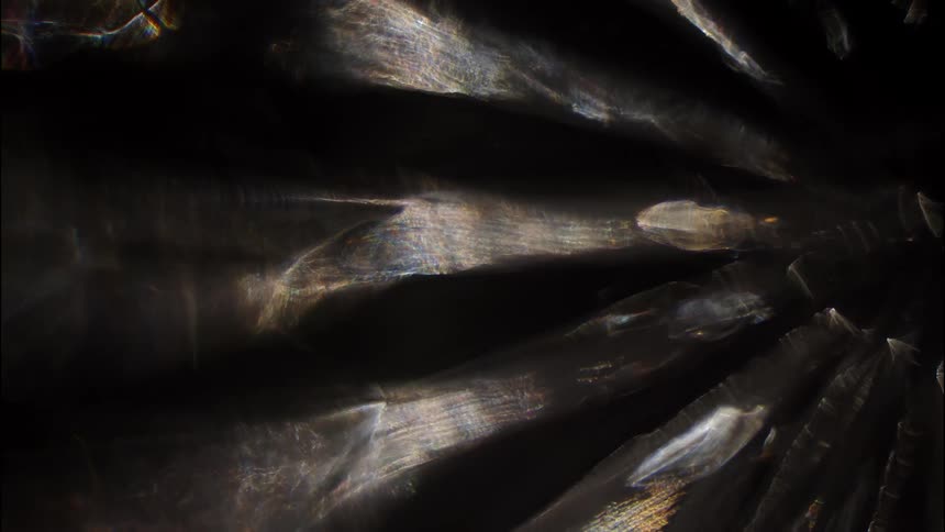 Walls of a cave are lit up in wedgeshaped bands