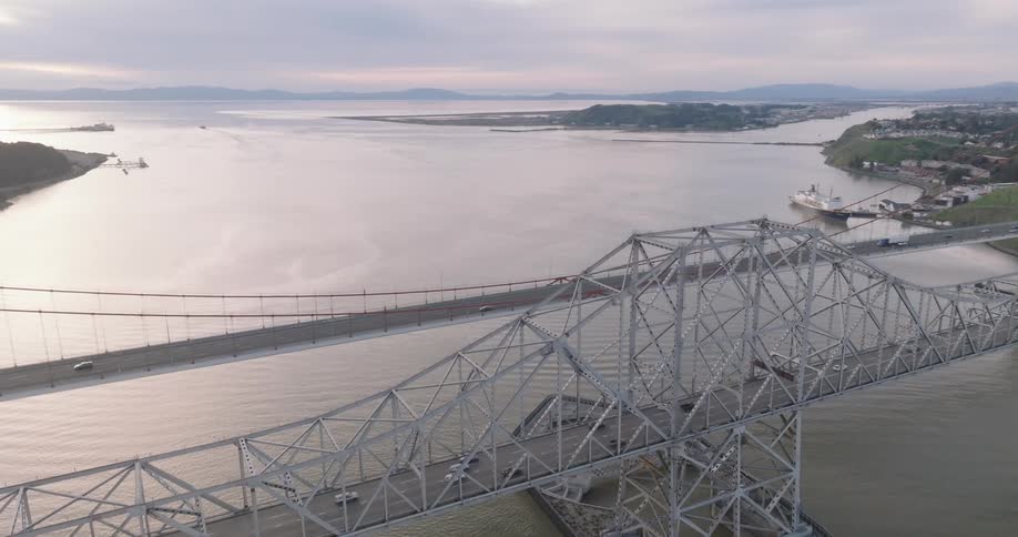 Aerial view of two bridges crossing a sea channel with vehicle traffic