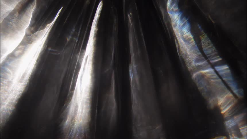 Abstract reflection of bright lights against a dark background