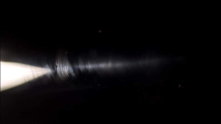 Abstract light beam against a black background
