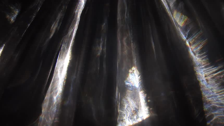 Sunlight shining through to different areas of a cave