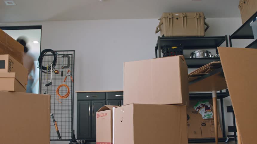 Man placing several boxes inside a room