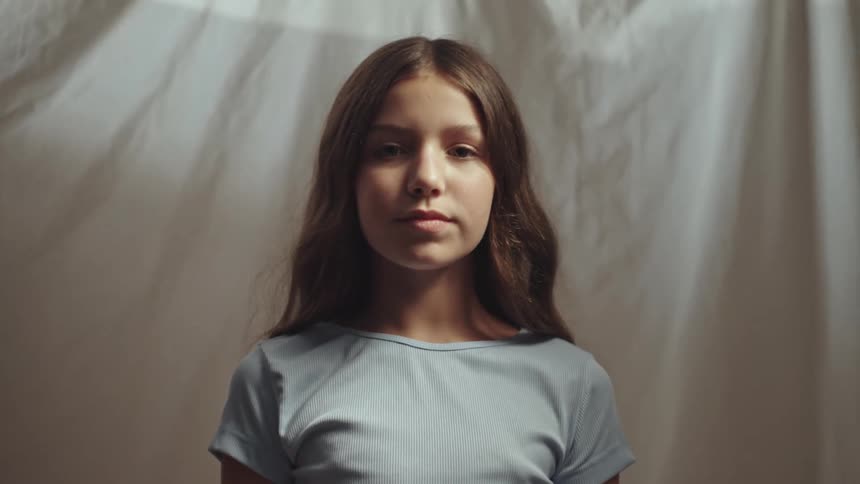 Close up portrait of a teenage girl standing indoors