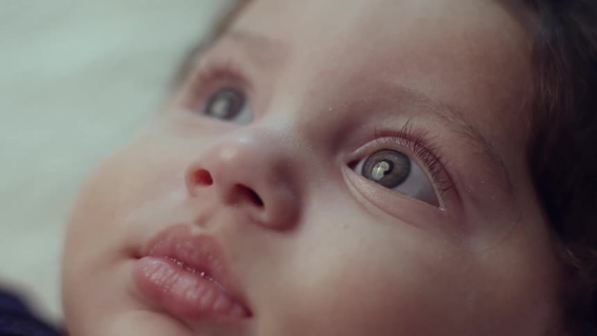 The baby is looking around