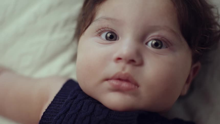 A baby stares into the distance