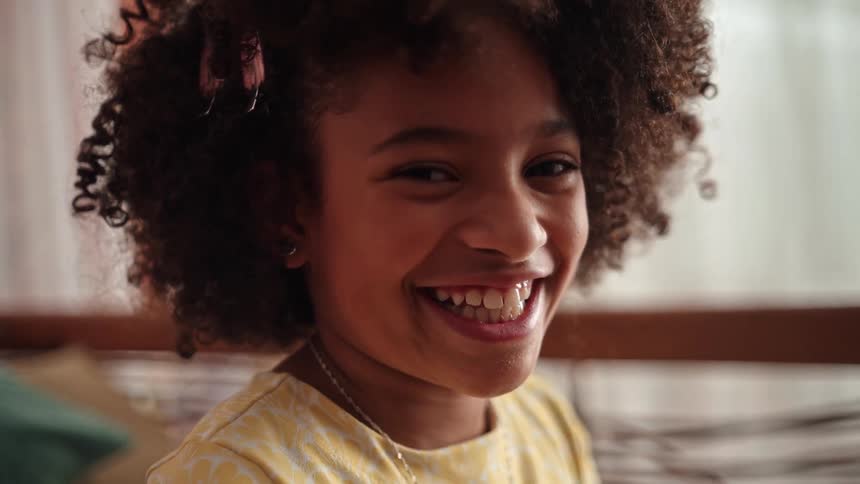 The girl smiles and blinks