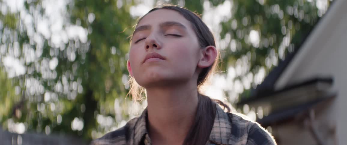 A teenager is resting with her eyes closed