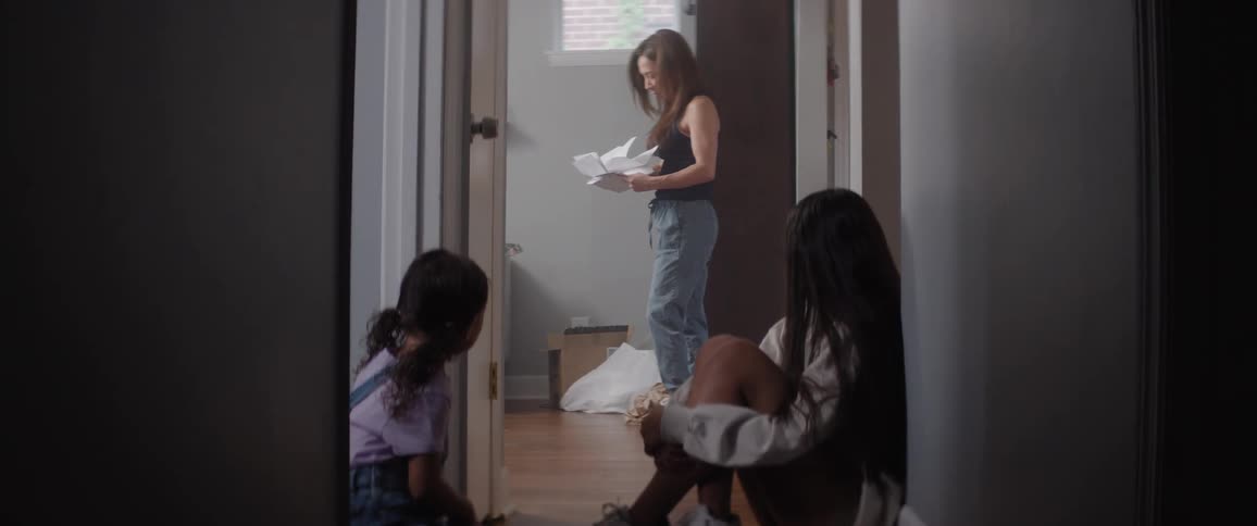 Mother paces and shuffles through papers as her worried daughters watch