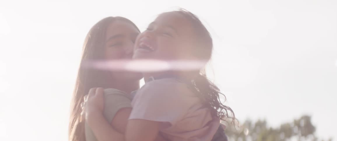 Girl holding her sister and spinning around