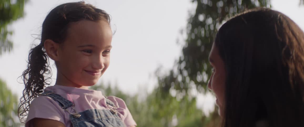 Two sisters are smiling at each other