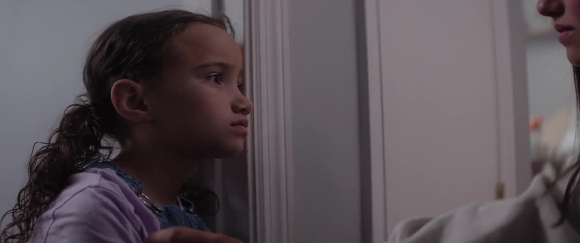 A child looks at another woman talking to her
