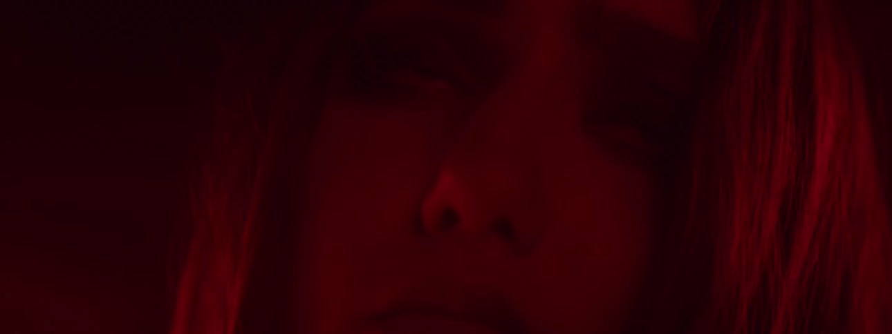 Woman with a scared expression and a person with a hand on her shoulder