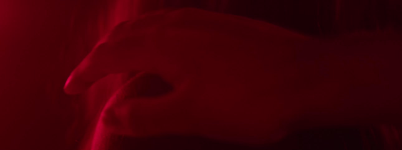 A hand clasps on the girls shoulder