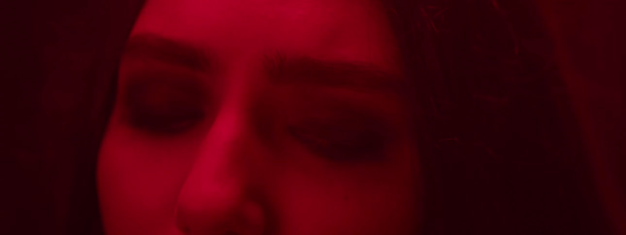 A red light is glowing on the girls face