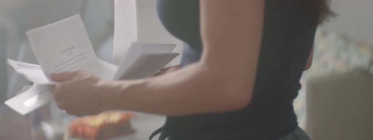 Woman walking through the room with cards in her hands