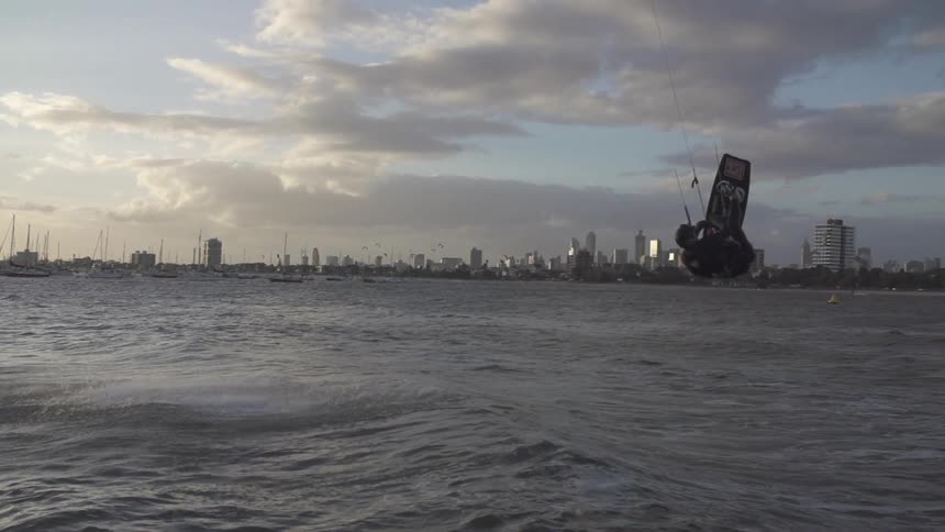 A man is windsurfing in the water